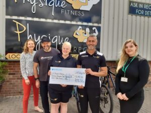 Pictured is Physique Fitness Staff with St Teresa's Staff, being presented an over sized cheque with their total fundraising amounts on it
